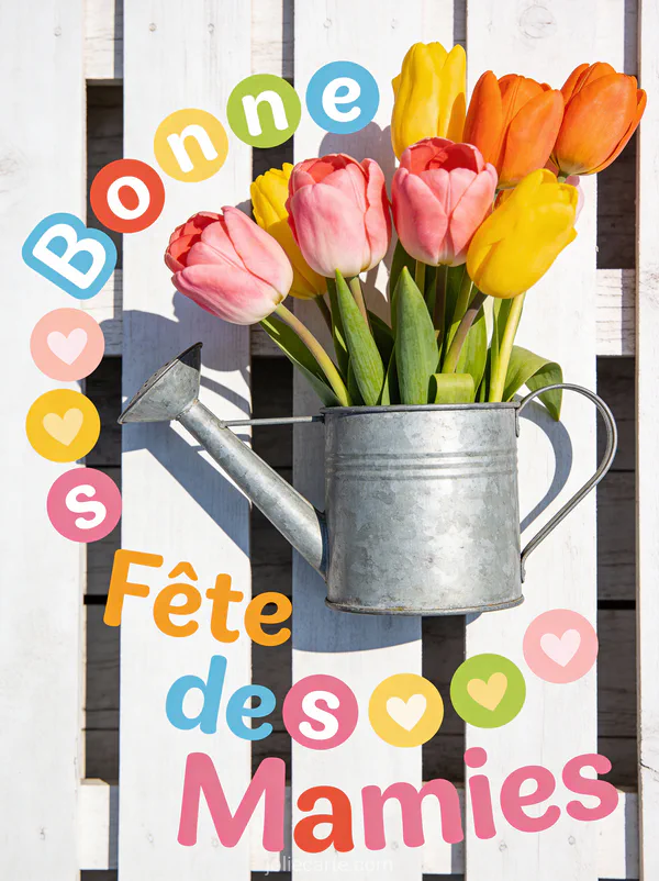 Bouquet de tulipes multicolores dans un arrosoir vintage en zinc sur fond bois blanchi texte Bonne Fête des Mamies