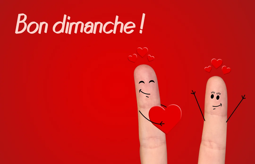 Deux doigts avec des visages souriants dessinés, l'un offrant un cœur à l'autre, sur un fond rouge vif avec l'inscription blanche 'Bon dimanche'.