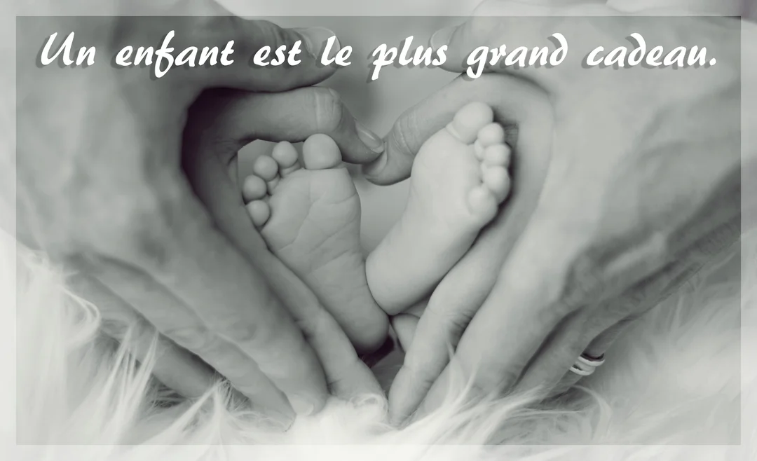 Photographie en noir et blanc de mains d'adulte formant un cœur autour des deux petits pieds d'un nouveau-né sur une surface douce et duveteuse.