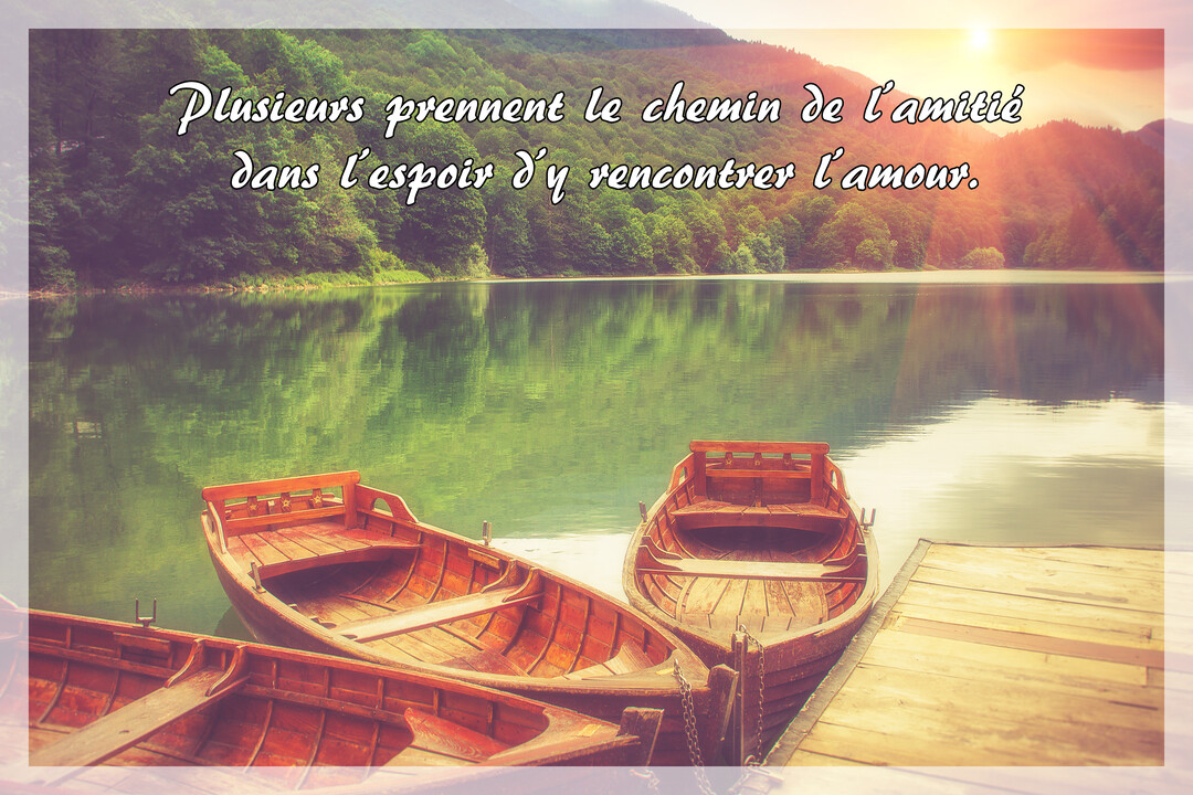 Des barques en bois sont amarrées à un ponton sur un lac calme, avec des montagnes boisées en arrière-plan sous une lumière dorée.