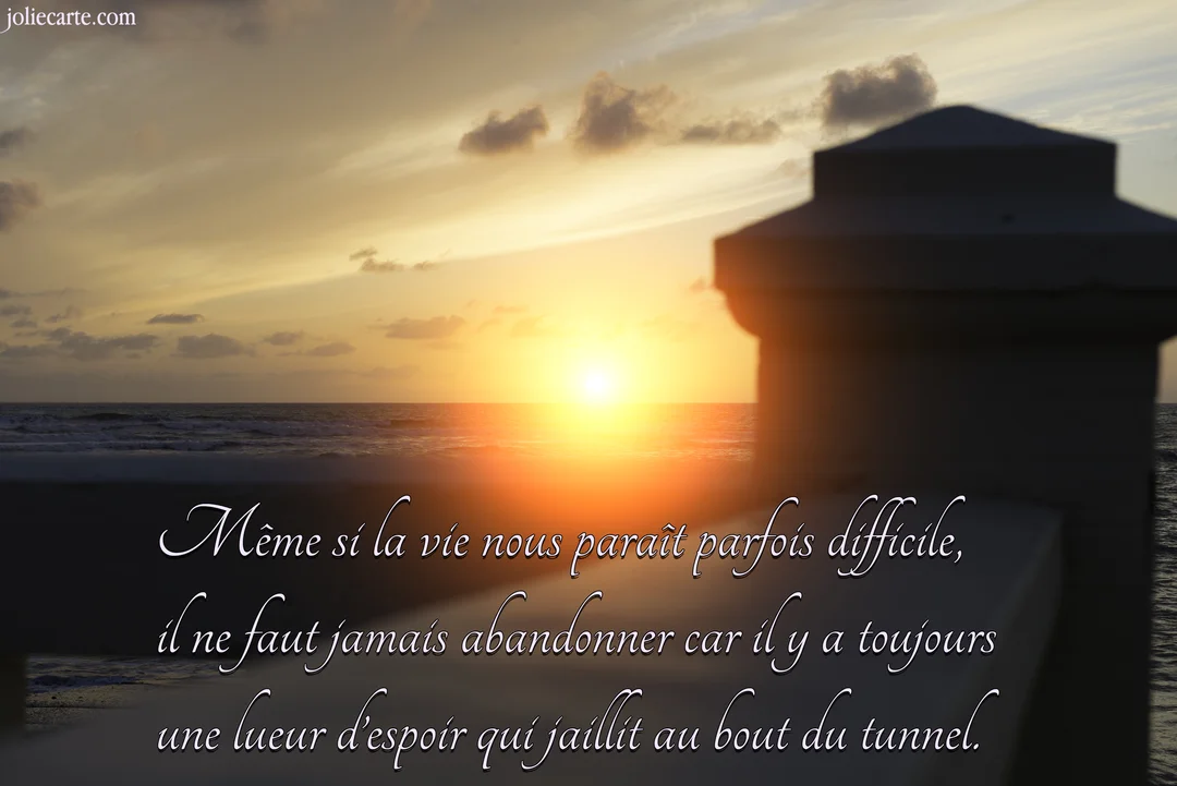 Photographie d'un coucher de soleil sur l'océan, avec une citation sur l'espoir superposée au premier plan sur une rambarde en bois.