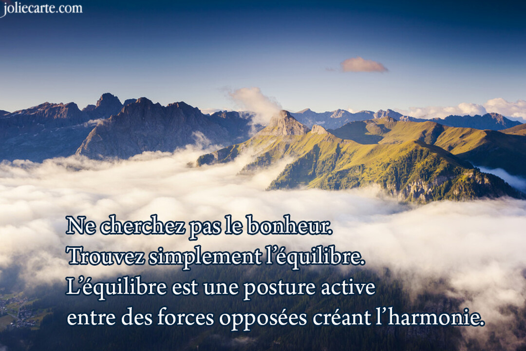 Une chaîne de montagnes aux sommets rocheux et verdoyants se dresse au-dessus d'une épaisse mer de nuages sous un ciel bleu dégagé.
