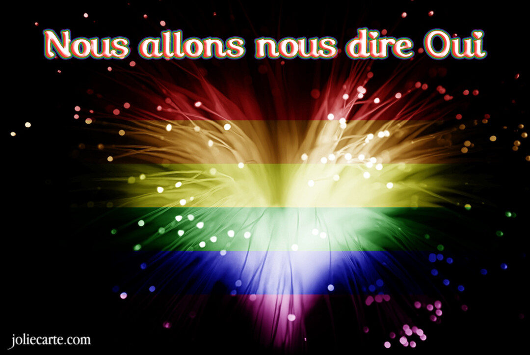 Un feu d'artifice éclate en formant les bandes colorées du drapeau arc-en-ciel, surmonté du texte blanc 'Nous allons nous dire Oui'.