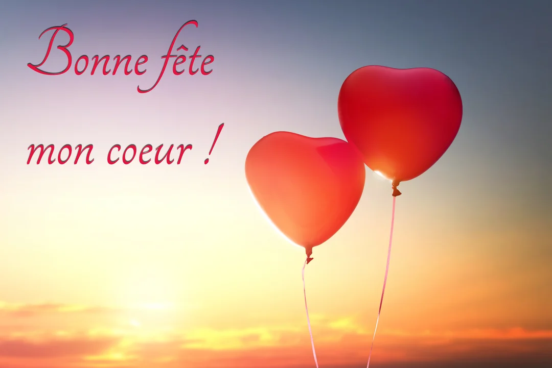 Deux ballons rouges en forme de cœur s'élèvent dans un ciel dégradé du jaune au violet, avec le texte 'Bonne fête mon coeur !'.