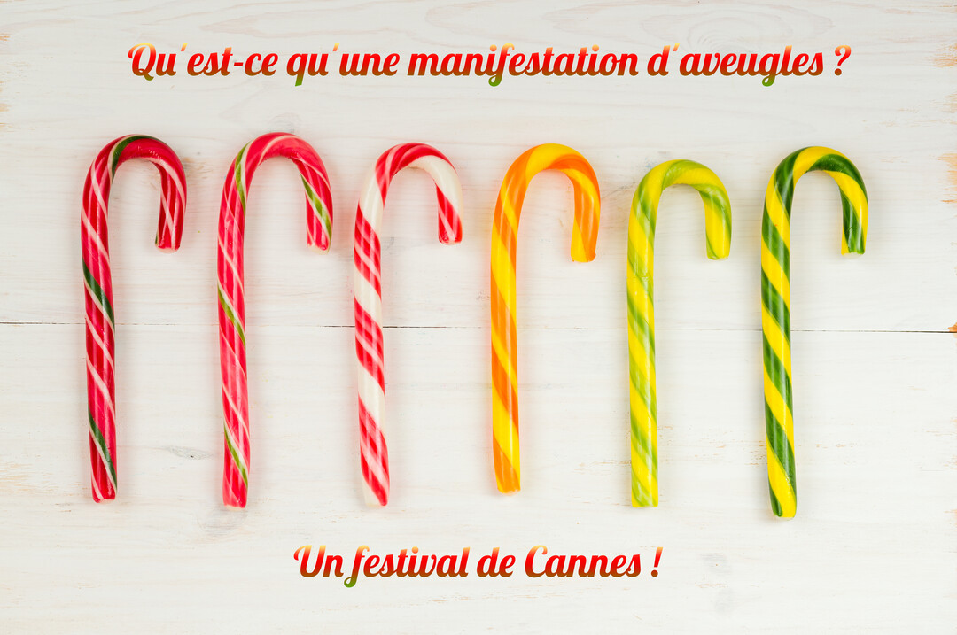 Six sucres d'orge colorés sont alignés horizontalement sur un fond en bois blanc, avec une blague écrite au-dessus et en-dessous.