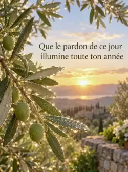 Gros plan d'une branche d'olivier aux feuilles vert argenté couvertes de rosée, éclairées par le soleil levant. Texte : « Que le pardon de ce jour illumine toute ton année ».